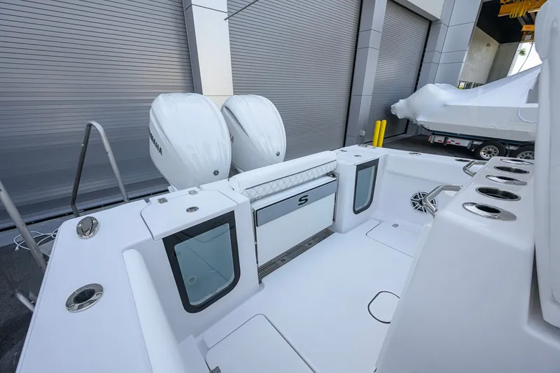 Slide: The Image of 2027 Sportsman Open 262 Center Console boat with dual engines and sleek design. - 24