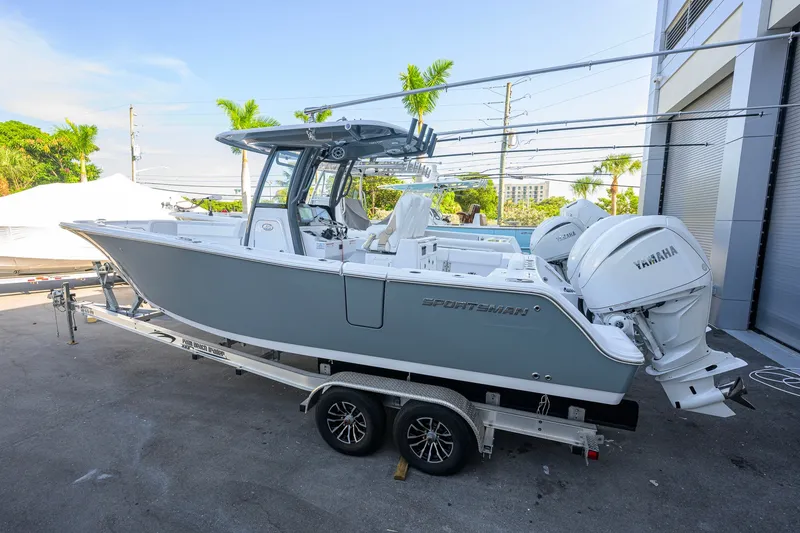 Slide: The Image of 2027 Sportsman Open 262 Center Console boat on trailer, featuring dual Yamaha engines. - 2