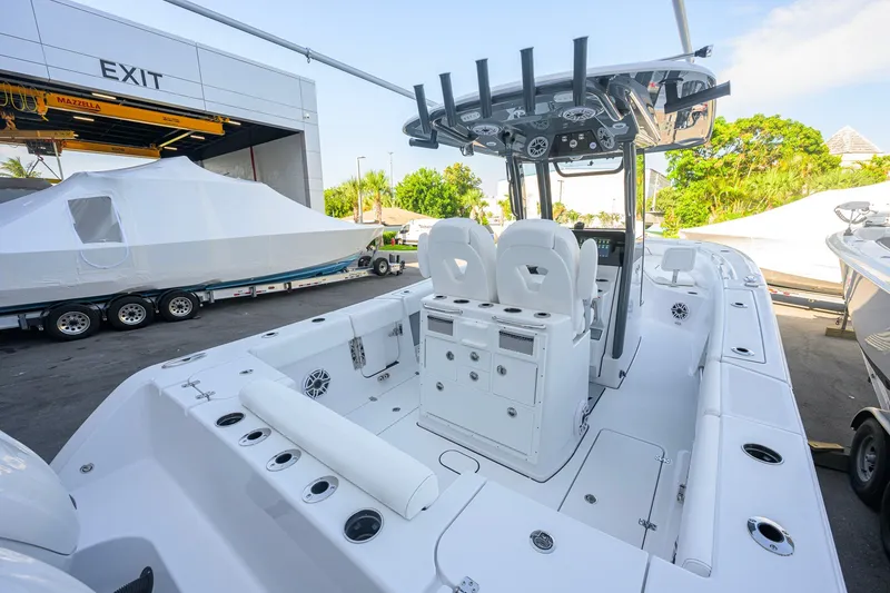 Slide: The Image of 2027 Sportsman Open 262 Center Console boat interior with dual seats and fishing rod holders. - 36