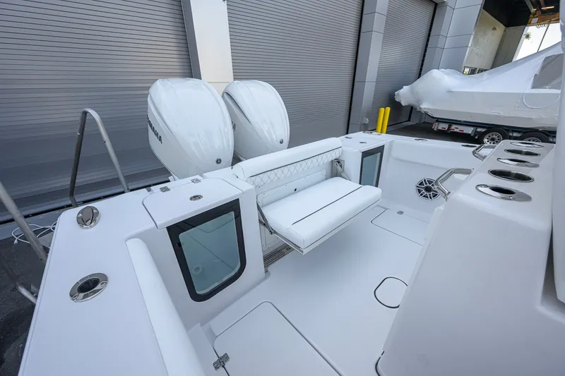 Slide: The Image of 2027 Sportsman Open 262 Center Console boat with dual engines and spacious seating. - 25