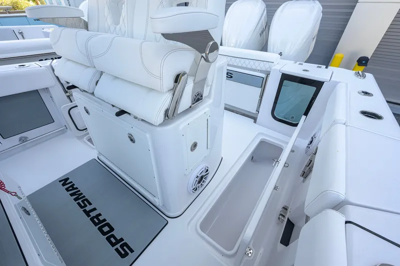 Slide: The Image of 2027 Sportsman Open 262 Center Console boat interior with white seating and storage compartments. - 42