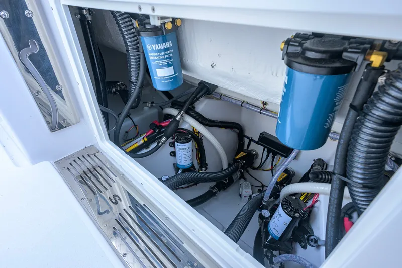 Slide: The Image of 2027 Sportsman Open 262 Center Console engine compartment with Yamaha marine filters and wiring. - 45
