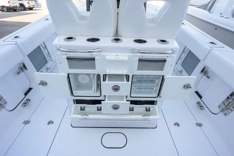 Slide: The Image of 2027 Sportsman Open 262 Center Console boat with open storage compartments and seating. - 40