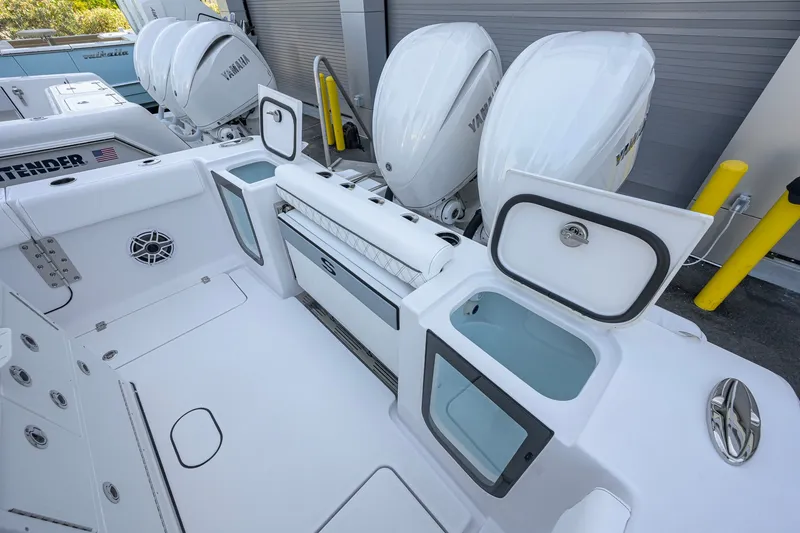 Slide: The Image of 2027 Sportsman Open 262 Center Console boat with Yamaha engines and open storage compartments. - 32