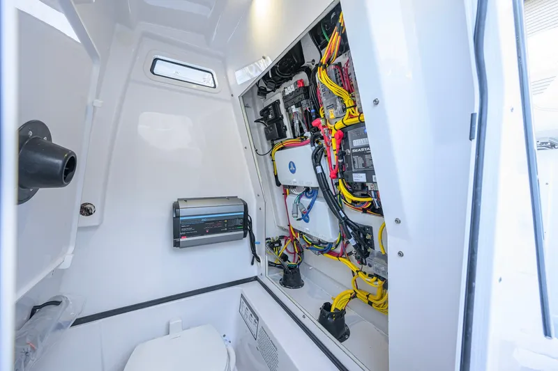 Slide: The Image of Interior view of 2027 Sportsman Open 262 Center Console boat's electrical system. - 49