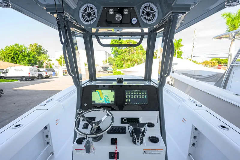 Slide: The Image of 2027 Sportsman Open 262 Center Console boat dashboard with navigation display and controls. - 7