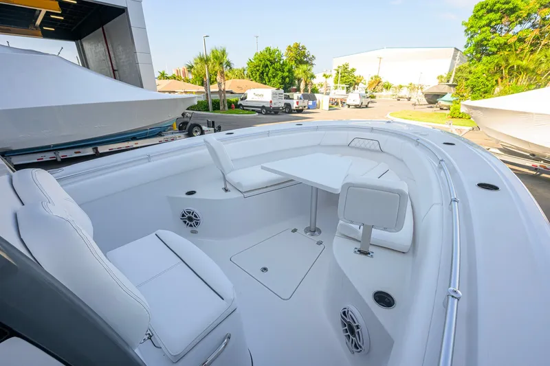 Slide: The Image of 2027 Sportsman Open 262 Center Console boat interior with seating and table. - 19