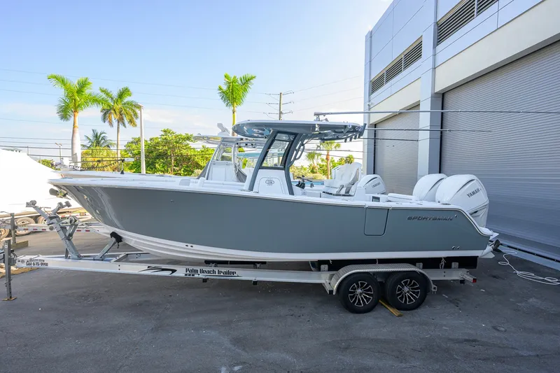 The Image of 2027 Sportsman Open 262 Center Console boat on trailer, parked outdoors. - 0