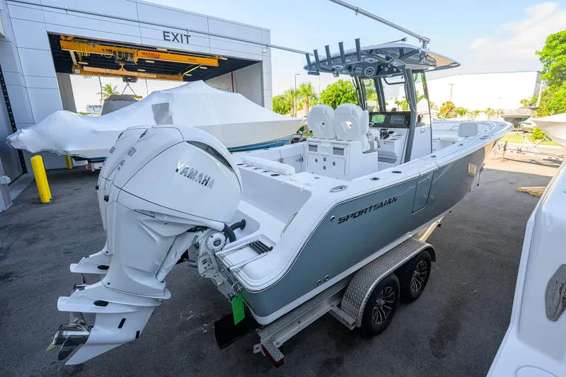 Slide: The Image of 2027 Sportsman Open 262 Center Console boat with dual Yamaha engines on a trailer. - 4