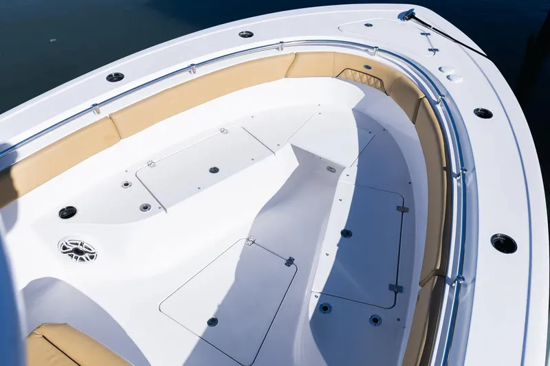 Slide: The Image of Manufacturer Provided Image: 2025 Sportsman Open 262 Center Console boat interior with cushioned seating and storage compartments. - 2