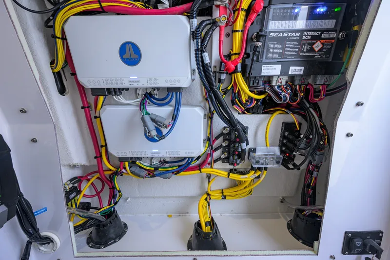 Slide: The Image of Electrical wiring and components inside a 2027 Sportsman Open 262 Center Console boat. - 50