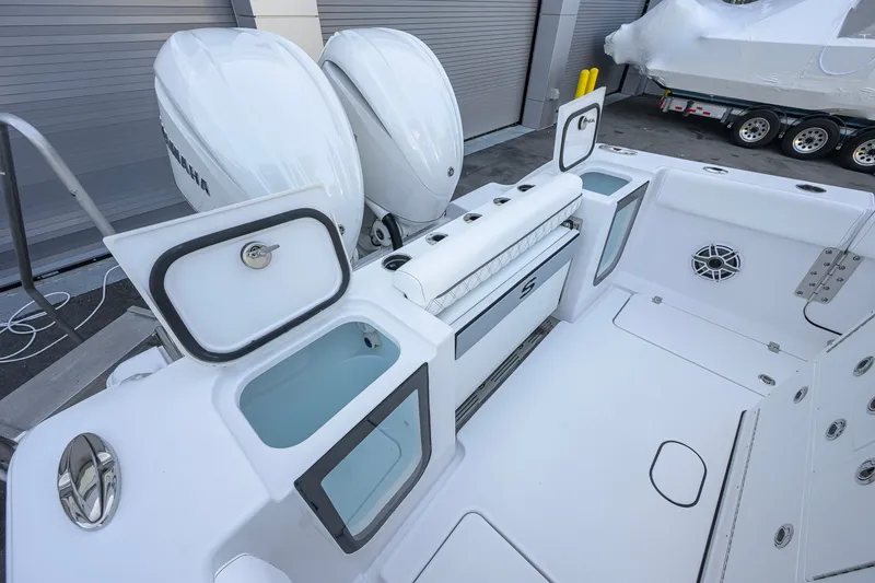 Slide: The Image of 2027 Sportsman Open 262 Center Console boat with dual engines and spacious deck layout. - 26