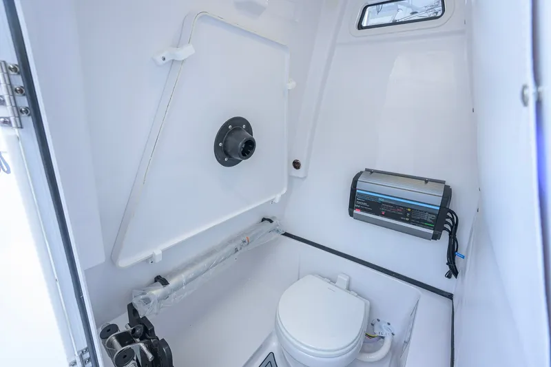 Slide: The Image of Interior of 2027 Sportsman Open 262 Center Console boat's compact bathroom. - 47