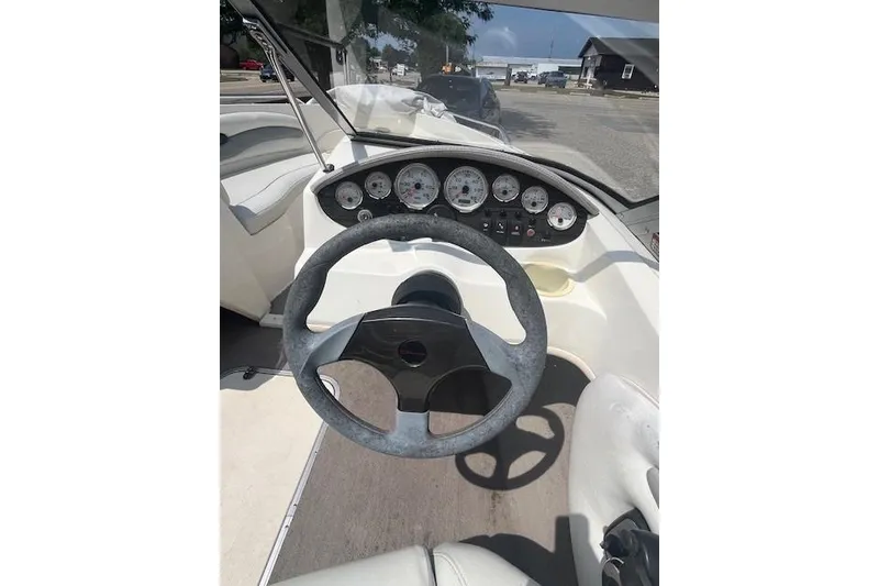 Slide: The Image of 2008 Stingray 195 LX boat dashboard with steering wheel and instrument panel. - 12