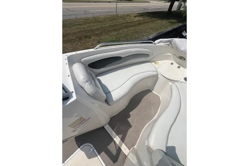 Slide: The Image of 2008 Stingray 195 LX boat interior with white cushioned seating. - 14