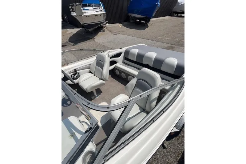 Slide: The Image of 2008 Stingray 195 LX boat interior with gray seating and steering wheel. - 5