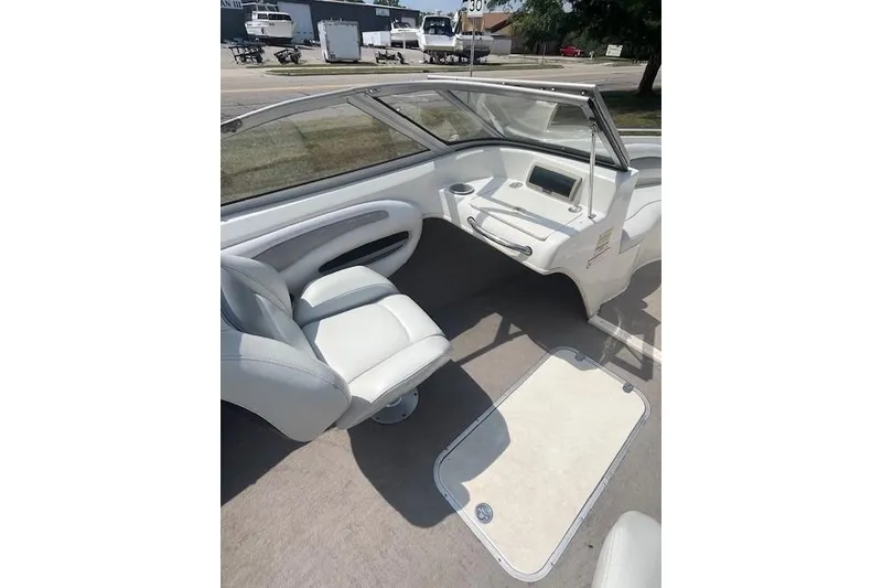 Slide: The Image of 2008 Stingray 195 LX boat interior with white seating and dashboard view. - 10