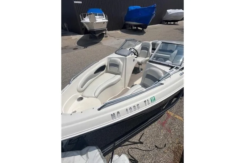 Slide: The Image of 2008 Stingray 195 LX boat with sleek design, parked outdoors. - 6