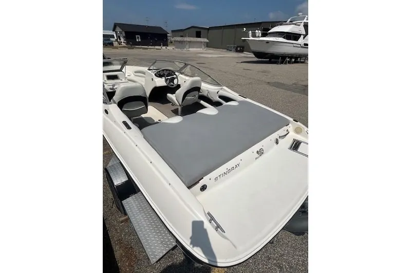 Slide: The Image of 2008 Stingray 195 LX boat with open cockpit, parked in a marina setting. - 4