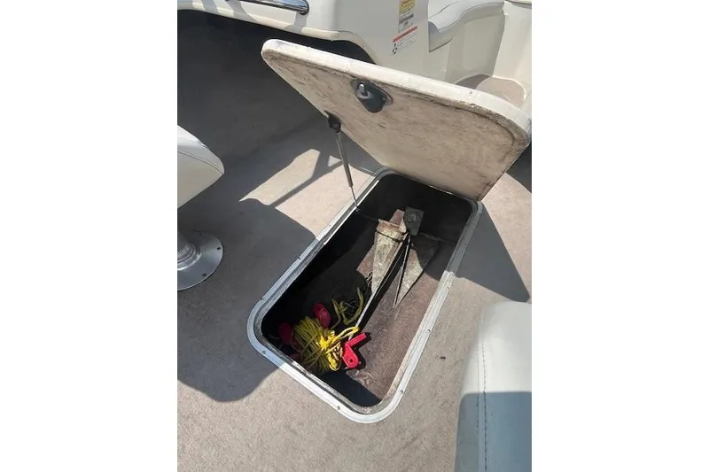 Slide: The Image of Open storage compartment in 2008 Stingray 195 LX boat, containing anchor and ropes. - 19
