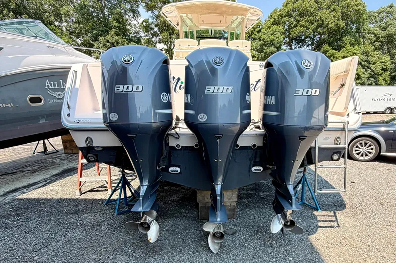 Slide: The Image of 2011 Grady-White Canyon 366 boat with triple Yamaha 300 engines, parked outdoors. - 20