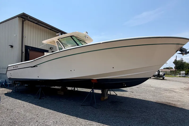 Slide: The Image of 2011 Grady-White Canyon 366 boat on stands outside a warehouse. - 18