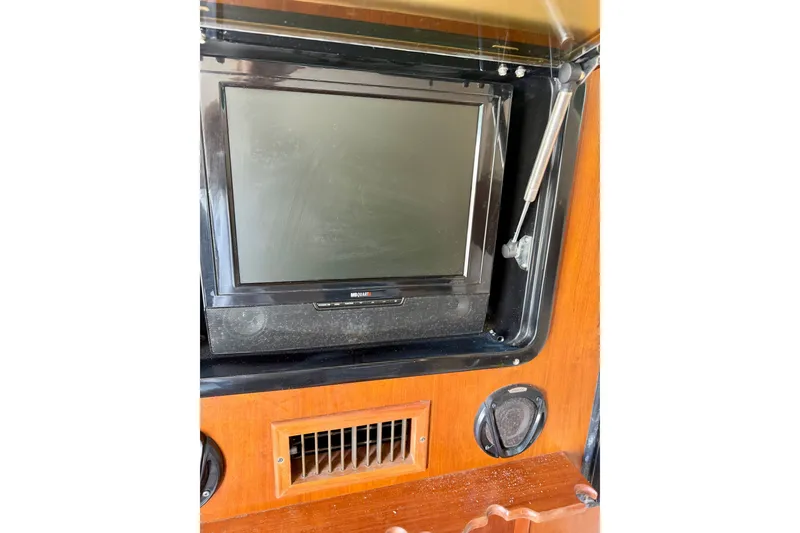 Slide: The Image of Dashboard of 2011 Grady-White Canyon 366 boat with monitor and vent. - 34