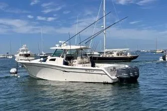 The Image of 2011 Grady-White Canyon 366 boat with fishing rods in a marina setting. - 0