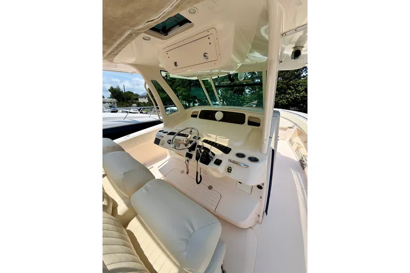 Slide: The Image of 2011 Grady-White Canyon 366 boat cockpit with steering wheel and control panel. - 26