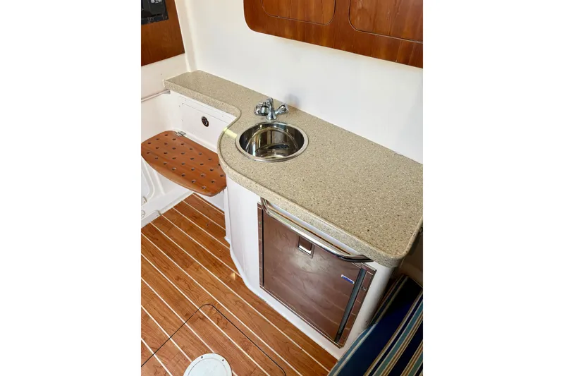 Slide: The Image of 2011 Grady-White Canyon 366 boat interior with sink, countertop, and wooden flooring. - 35