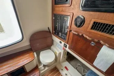 Slide: The Image of 2011 Grady-White Canyon 366 boat interior with toilet and control panel. - 14