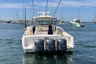 Slide: The Image of 2011 Grady-White Canyon 366 boat with triple outboard engines on calm water. - 1