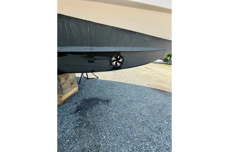 Slide: The Image of 2011 Grady-White Canyon 366 boat hull with visible thruster on gravel surface. - 19