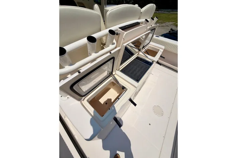 Slide: The Image of 2011 Grady-White Canyon 366 boat deck with open storage compartments and rod holders. - 22