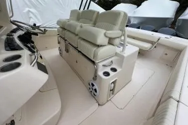 Slide: The Image of 2011 Grady-White Canyon 366 boat interior with cushioned seating and cup holders. - 7