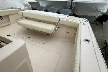 Slide: The Image of 2011 Grady-White Canyon 366 boat interior with cushioned seating and storage compartments. - 12