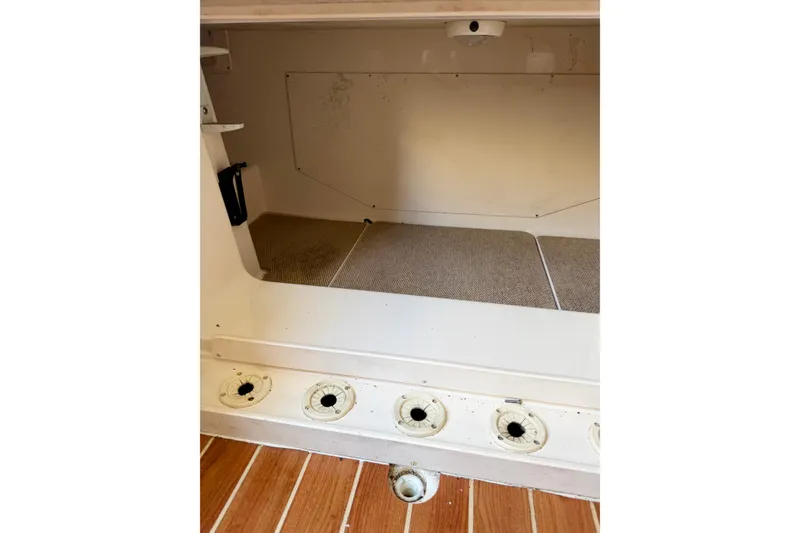 Slide: The Image of Interior storage compartment of 2011 Grady-White Canyon 366 boat with wooden flooring. - 33