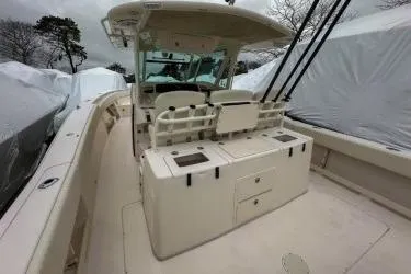 Slide: The Image of 2011 Grady-White Canyon 366 boat interior with fishing rod holders and storage compartments. - 6