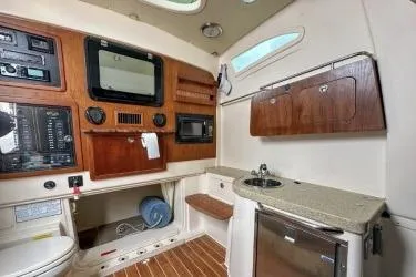 Slide: The Image of 2011 Grady-White Canyon 366 cabin interior with wood accents and modern amenities. - 13