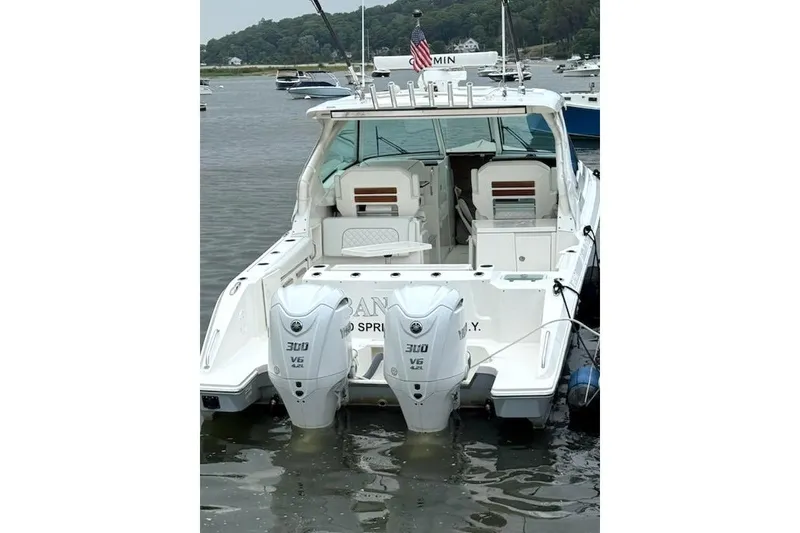 Slide: The Image of 2024 Pursuit DC 326 Dual Console boat with twin 300 V6 engines docked in a marina. - 23