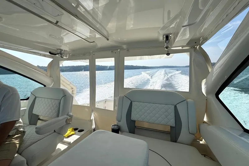 Slide: The Image of Interior view of 2024 Pursuit DC 326 Dual Console cruising on a sunny day. - 26