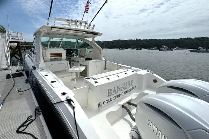 Slide: The Image of 2024 Pursuit DC 326 Dual Console boat docked, featuring Yamaha engines and spacious seating. - 3