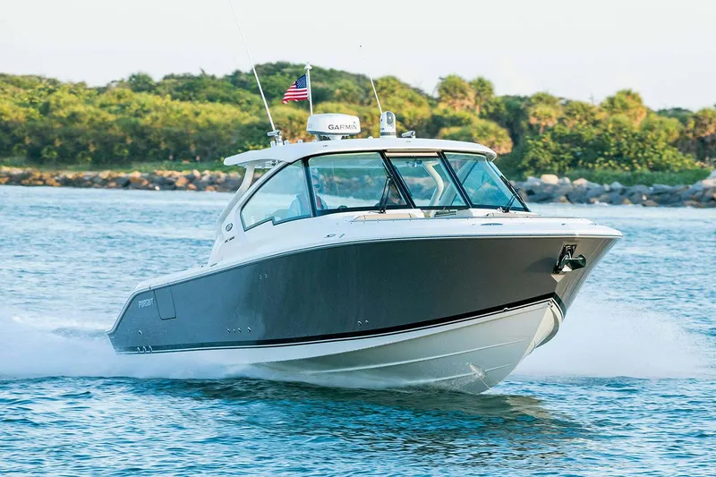 Slide: The Image of Manufacturer Provided Image: 2024 Pursuit DC 326 Dual Console boat cruising on water. - 1