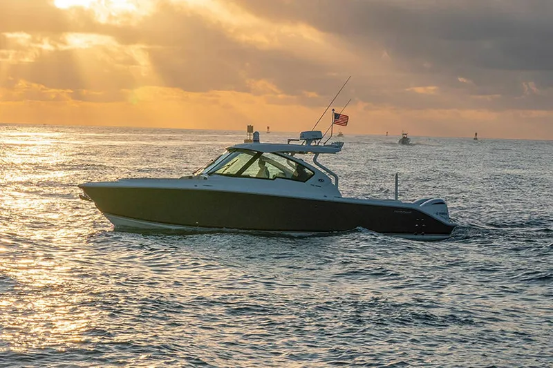 Slide: The Image of Manufacturer Provided Image: 2024 Pursuit DC 326 Dual Console boat cruising at sunset. - 17