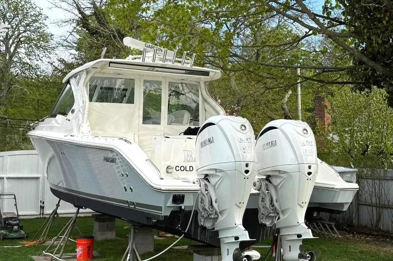 Slide: The Image of 2024 Pursuit DC 326 Dual Console boat with twin Yamaha engines, displayed outdoors. - 27