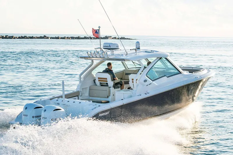 Slide: The Image of Manufacturer Provided Image: 2024 Pursuit DC 326 Dual Console boat cruising on open water. - 2
