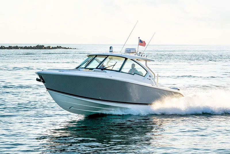 Slide: The Image of Manufacturer Provided Image: 2024 Pursuit DC 326 Dual Console boat cruising on open water. - 7