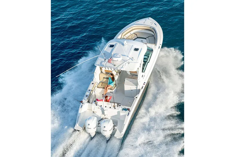 Slide: The Image of Manufacturer Provided Image: 2024 Pursuit DC 326 Dual Console boat cruising on open water. - 14