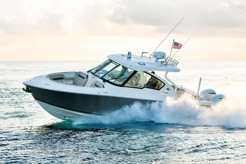Slide: The Image of Manufacturer Provided Image: 2024 Pursuit DC 326 Dual Console boat cruising on the ocean. - 6
