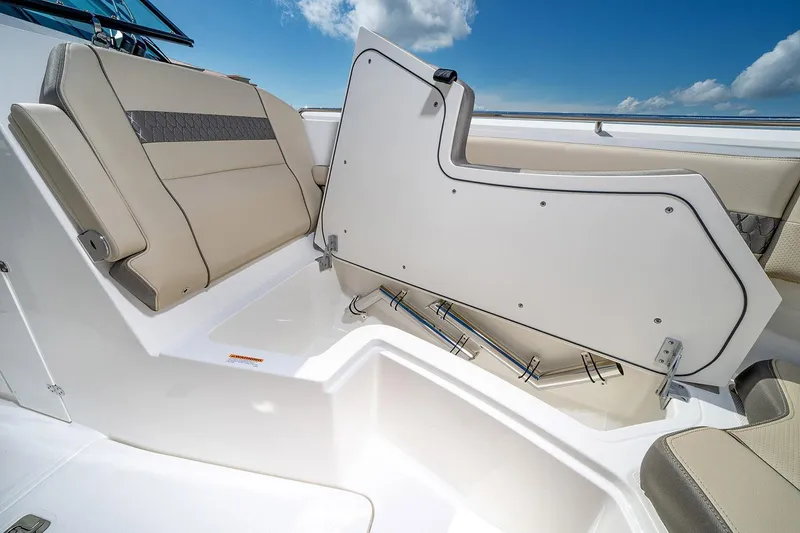 Slide: The Image of Manufacturer Provided Image: 2024 Pursuit DC 326 Dual Console boat with open storage compartment and cushioned seating. - 12